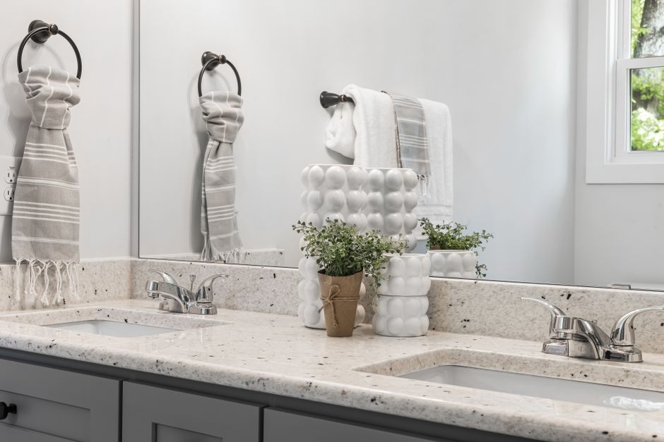 A minimalist bathroom with double sinks, modern fixtures, and stylish decor.